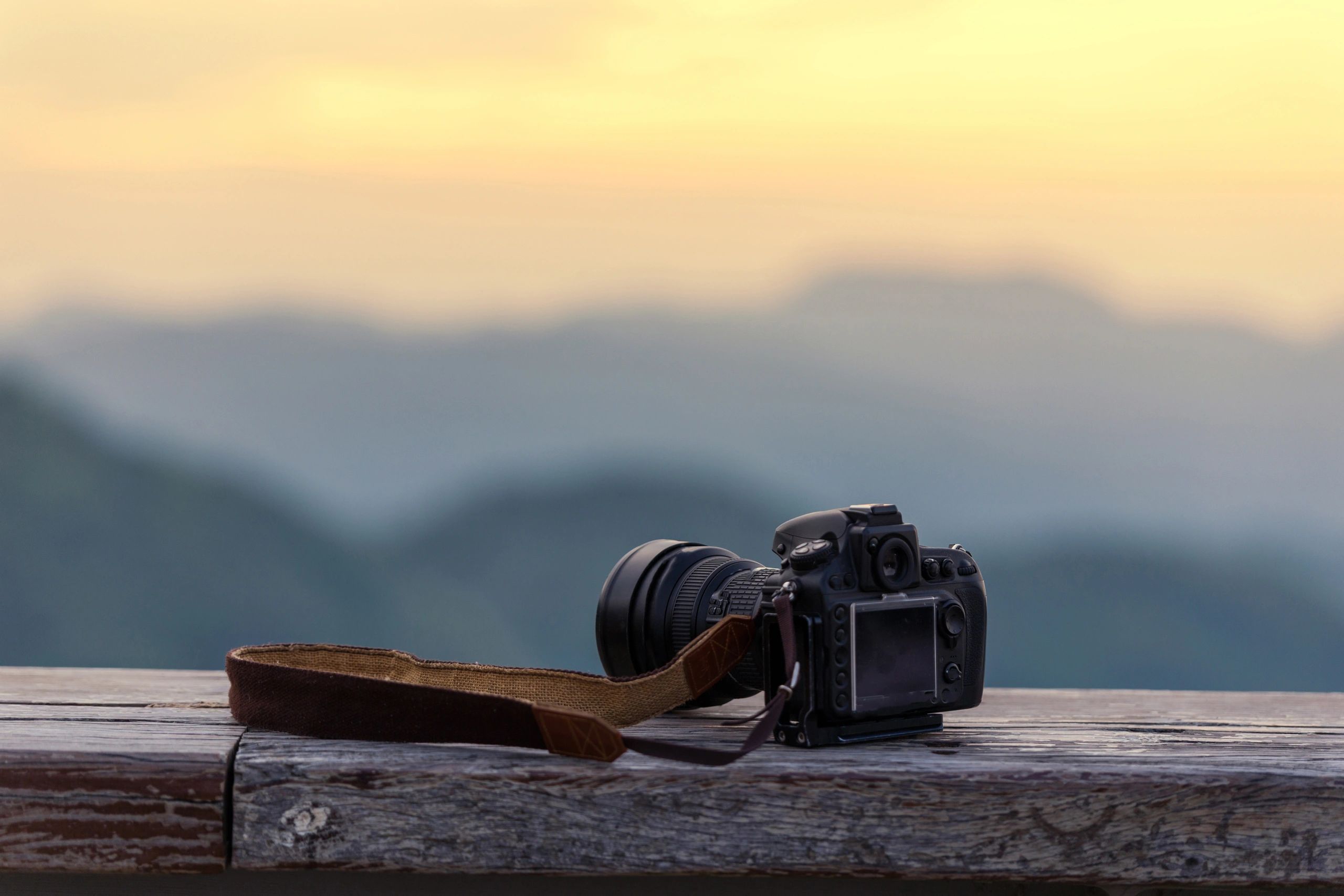 Photographer capturing a misty sunrise